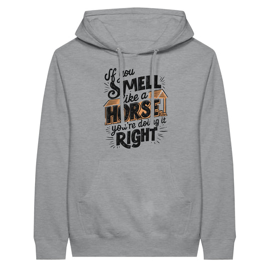 Funny hoodie for horse lovers in gray with a graphic design that says 'If you smell like a horse, you're doing it right'